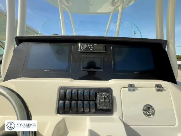 Slide: The Image of 2024 Sailfish 242 CC dashboard with dual screens and control panel. - 11