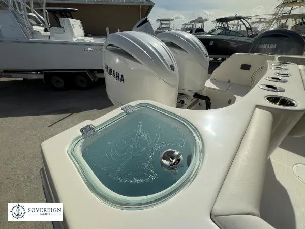Slide: The Image of 2024 Sailfish 242 CC boat with Yamaha engines and Sovereign Yacht branding. - 16