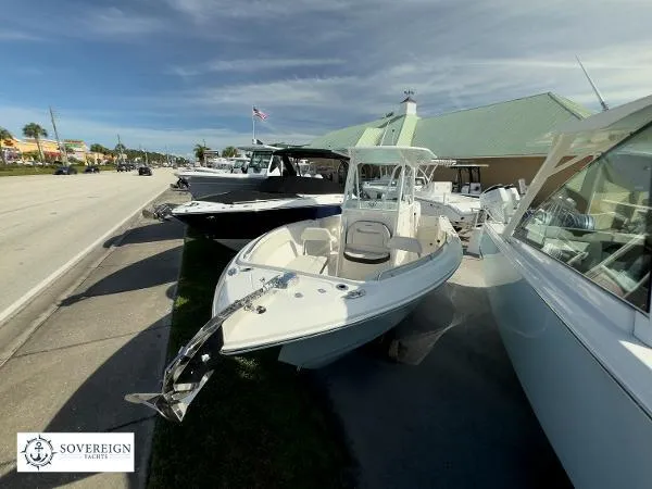 Slide: The Image of 2024 Sailfish 242 CC boat displayed at Sovereign Yachts dealership. - 2