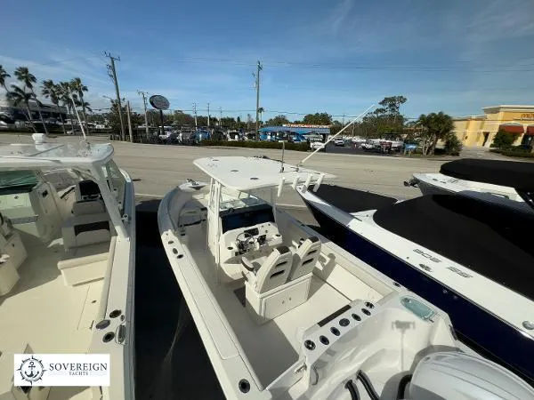 Slide: The Image of 2024 Sailfish 242 CC boat displayed at Sovereign Yacht dealership. - 24