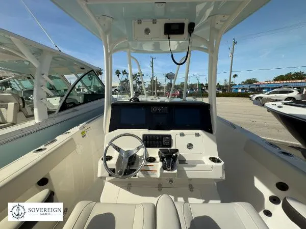 Slide: The Image of 2024 Sailfish 242 CC boat cockpit with steering wheel and control panel. - 27