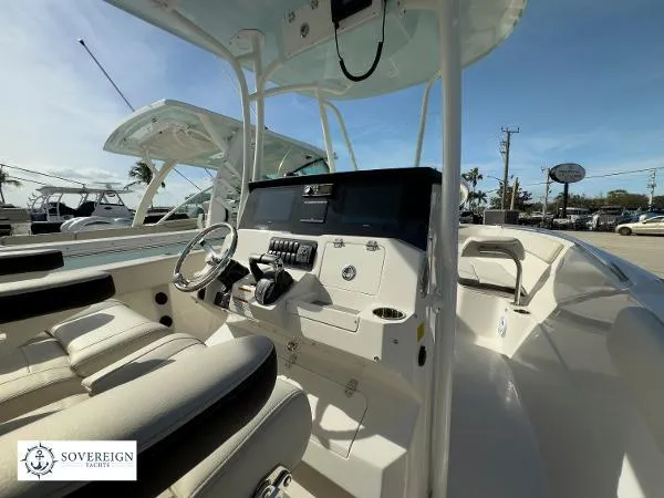 Slide: The Image of 2024 Sailfish 242 CC boat interior with modern helm and seating, displayed by Sovereign Yachts. - 28
