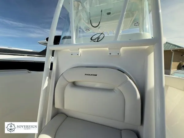 Slide: The Image of 2024 Sailfish 242 CC boat interior with white seating and console, Sovereign Yachts logo visible. - 6