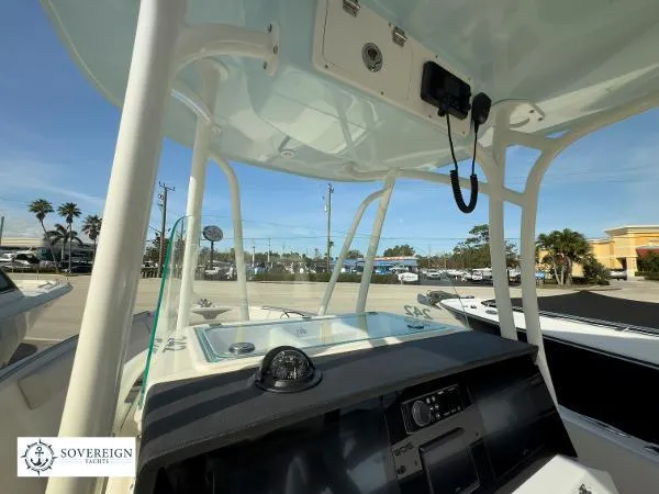 Slide: The Image of 2024 Sailfish 242 CC boat console with T-top and navigation equipment. - 7