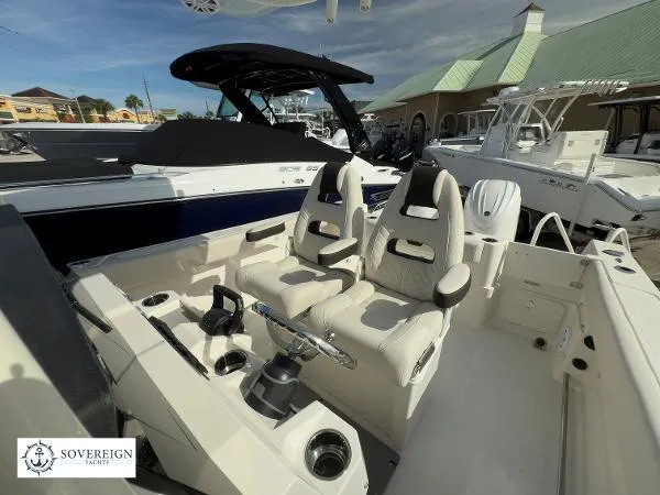 Slide: The Image of 2024 Sailfish 242 CC boat interior with dual seats and steering console. - 8