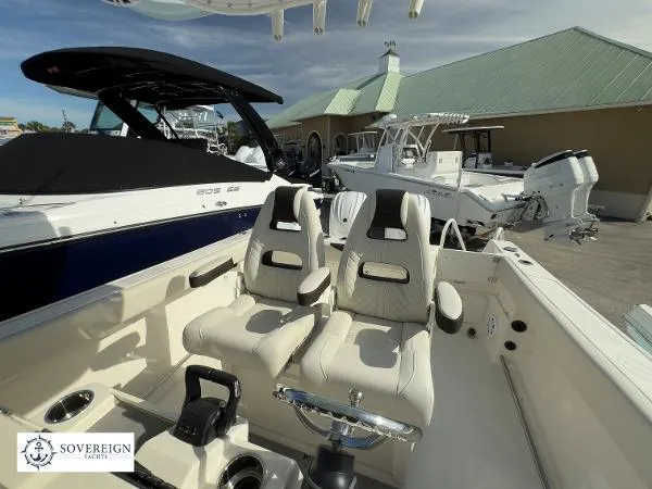 Slide: The Image of 2024 Sailfish 242 CC boat interior with dual seats at Sovereign Yachts dealership. - 9