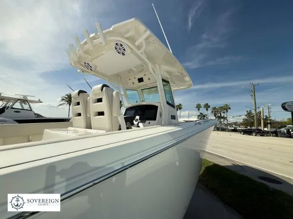Slide: The Image of 2024 Sailfish 312 boat with dual seats, docked under clear skies. - 10
