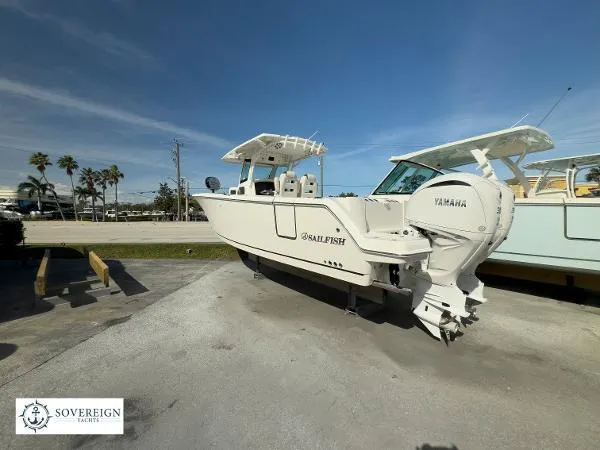 Slide: The Image of 2024 Sailfish 312 boat with Yamaha engine, displayed outdoors under clear blue sky. - 11