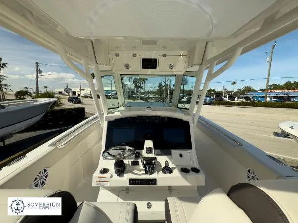 Slide: The Image of 2024 Sailfish 312 boat cockpit with advanced navigation controls and seating, displayed by Sovereign Yachts. - 13