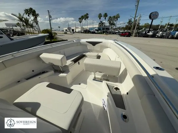 Slide: The Image of 2024 Sailfish 312 boat interior with seating, docked under a clear sky. - 14