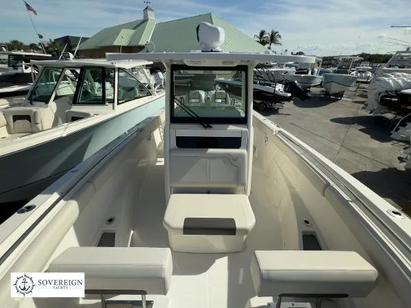 Slide: The Image of 2024 Sailfish 312 boat interior with seating, docked at a marina under clear skies. - 15