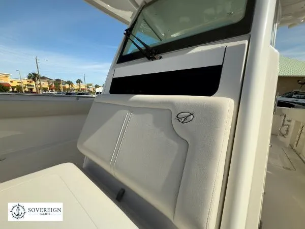 Slide: The Image of 2024 Sailfish 312 boat interior with cushioned seating and window, Sovereign Yachts logo visible. - 16
