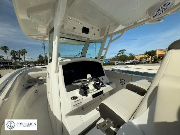 Slide: The Image of 2024 Sailfish 312 boat interior with modern helm, steering wheel, and seating. - 18