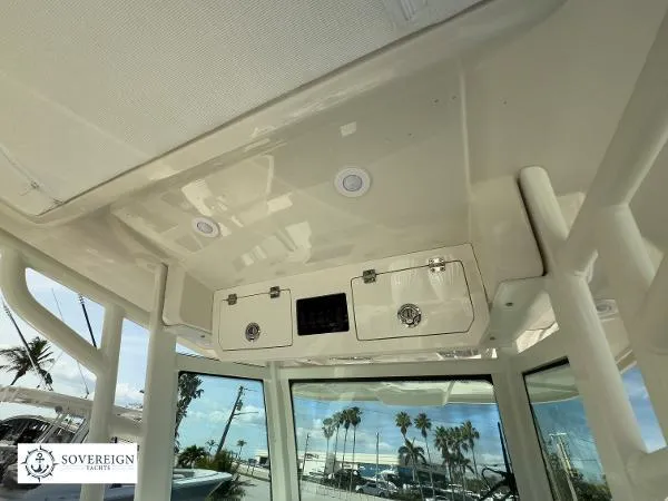Slide: The Image of 2024 Sailfish 312 boat interior with storage compartments and overhead lighting. - 22