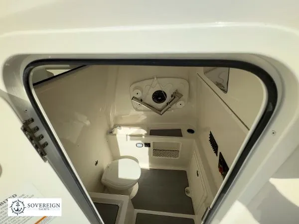 Slide: The Image of 2024 Sailfish 312 boat interior, featuring a compact, modern bathroom with toilet and storage. - 25