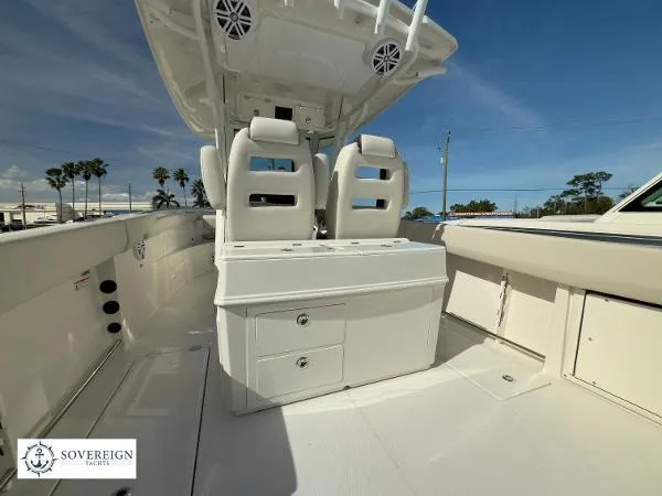 Slide: The Image of 2024 Sailfish 312 boat interior with dual seats and storage, under clear blue sky. - 28