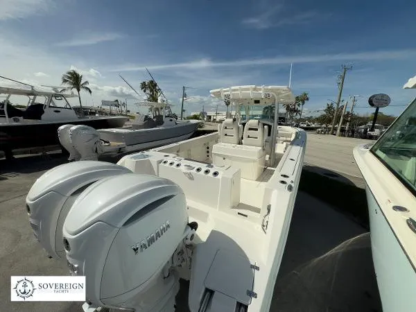 Slide: The Image of 2024 Sailfish 312 boat with dual Yamaha engines, docked under a clear blue sky. - 9