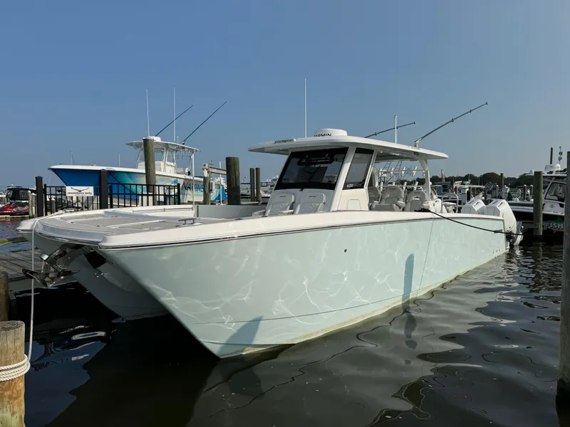 Slide: The Image of 2025 Twin Vee 400 GFX boat docked at a marina. - 11