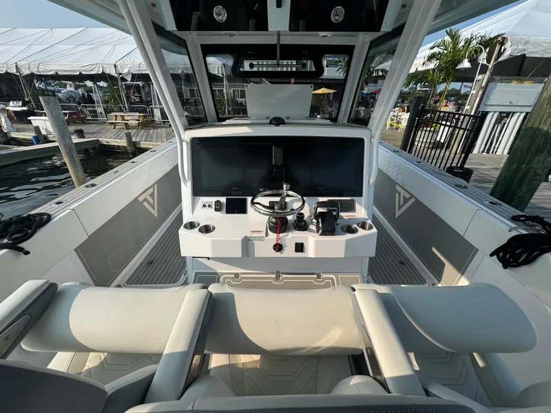 Slide: The Image of 2025 Twin Vee 400 GFX boat cockpit with modern controls and dual screens. - 18