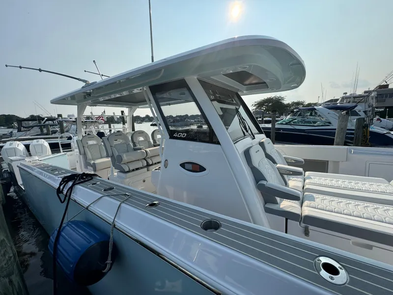 Slide: The Image of 2025 Twin Vee 400 GFX boat docked at marina, side view. - 25