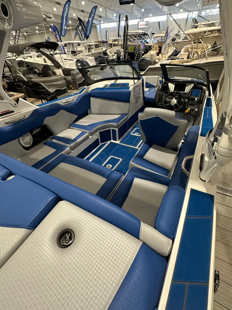 Slide: The Image of 2023 Supreme ZS212 boat interior with blue and white seating at a boat show. - 6