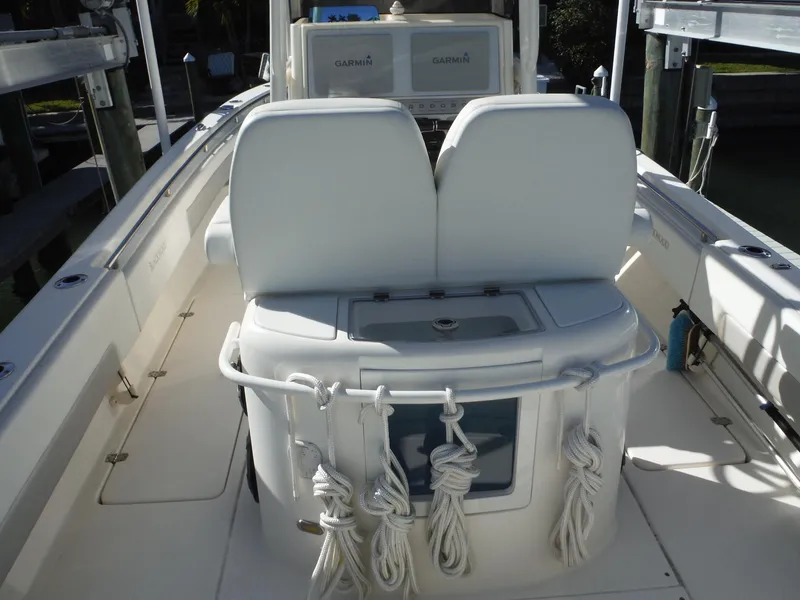Slide: The Image of 2020 Blackwood 270 Open Center Console boat interior with white seating and storage. - 15