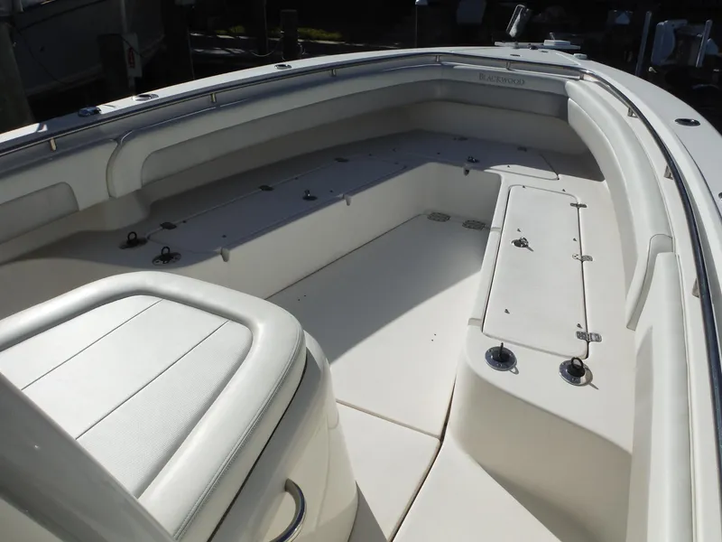 Slide: The Image of 2020 Blackwood 270 Open Center Console boat interior with seating and storage compartments. - 19