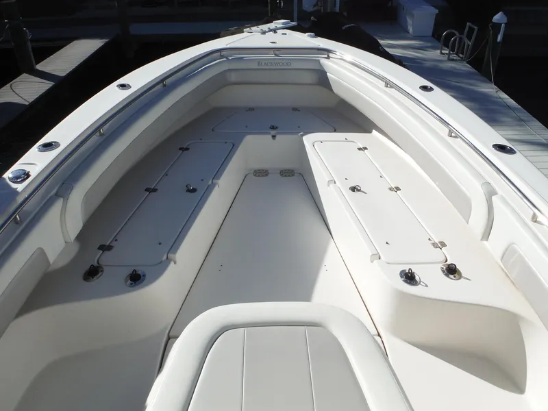 Slide: The Image of 2020 Blackwood 270 Open Center Console boat interior, white seating and storage compartments. - 32