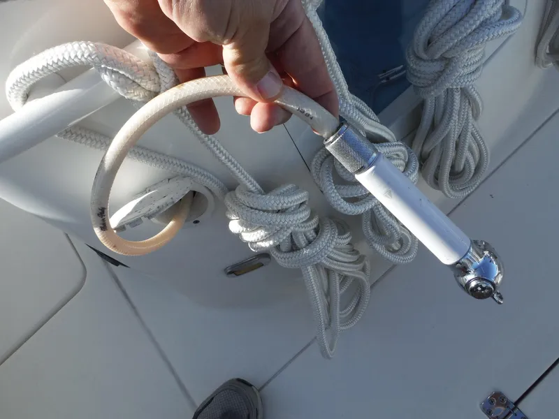 Slide: The Image of Hand holding a hose on a 2020 Blackwood 270 Open Center Console boat. - 40