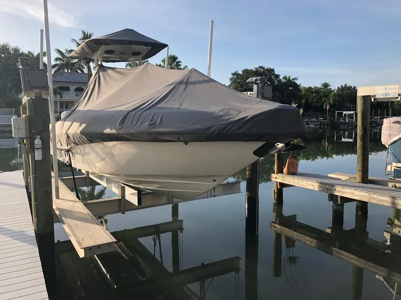 Slide: The Image of 2020 Blackwood 270 Open Center Console boat covered and docked. - 45