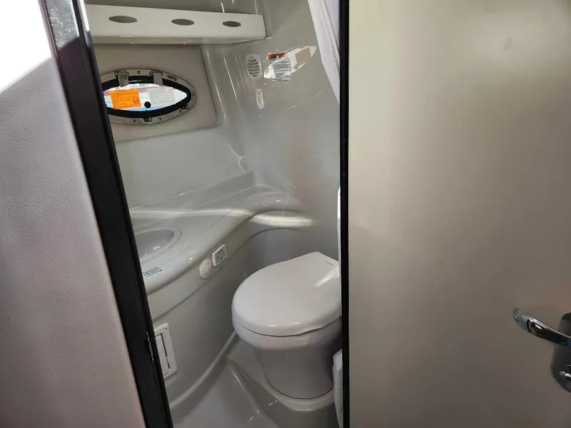 Slide: The Image of 2024 Crownline 280 CRX boat bathroom with toilet and sink. - 10