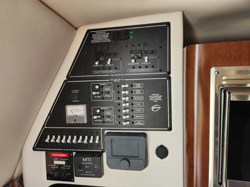 Slide: The Image of Control panel of a 2024 Crownline 280 CRX boat with various switches and meters. - 12