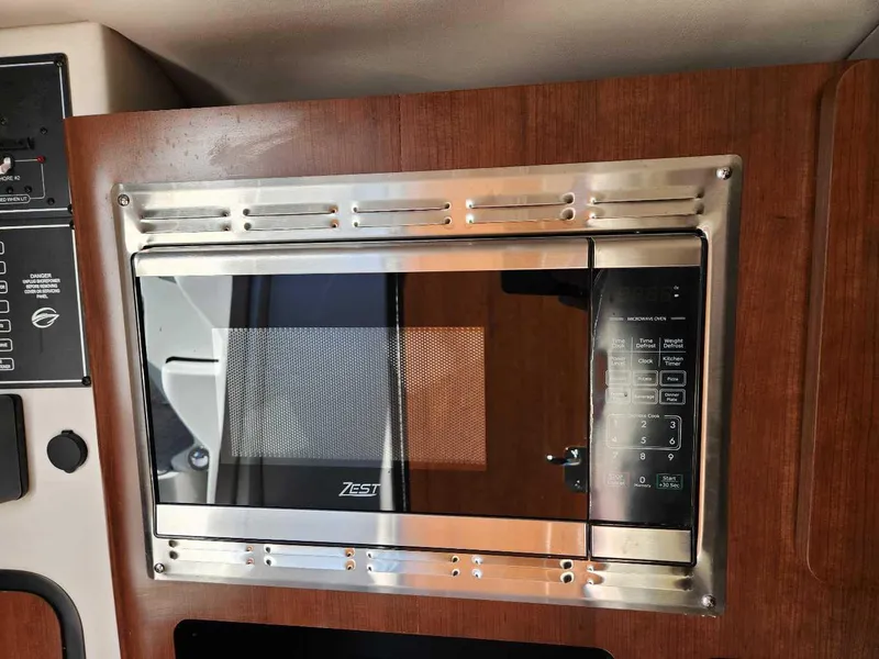 Slide: The Image of Built-in microwave in 2024 Crownline 280 CRX boat galley. - 13