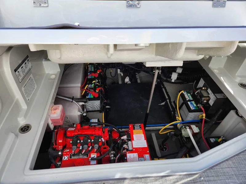 Slide: The Image of 2024 Crownline 280 CRX engine compartment with batteries and wiring. - 15