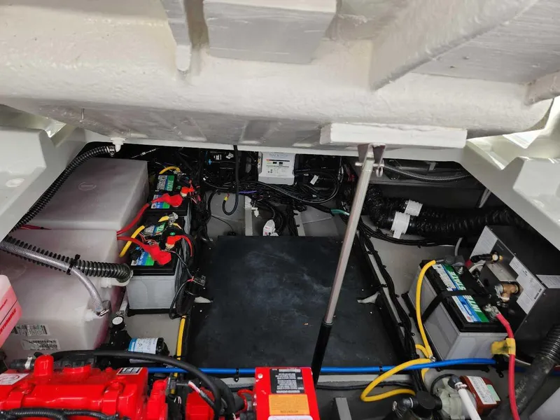 Slide: The Image of Engine compartment of 2024 Crownline 280 CRX boat with batteries and wiring. - 16