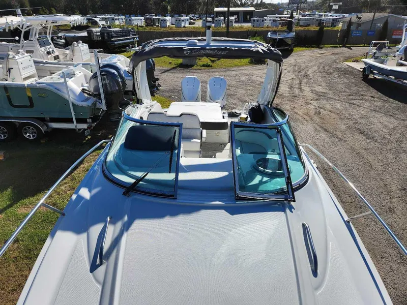 Slide: The Image of 2024 Crownline 280 CRX boat on display at a marina. - 2