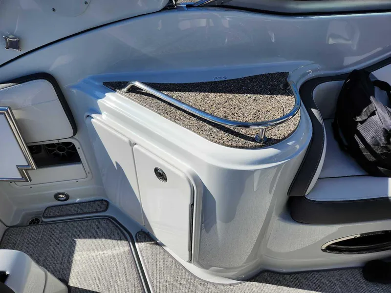 Slide: The Image of 2024 Crownline 280 CRX boat interior with storage compartment and seating. - 22