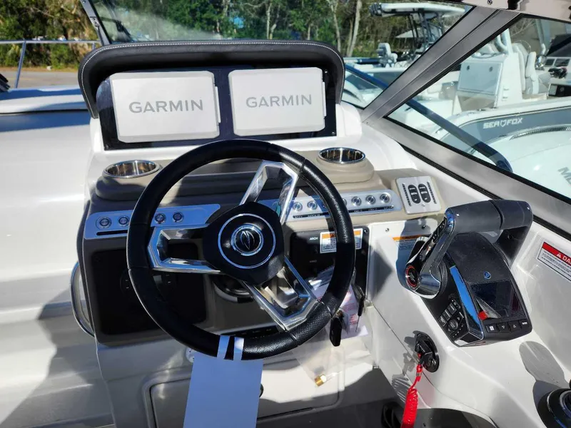 Slide: The Image of 2024 Crownline 280 CRX boat helm with Garmin navigation displays and modern controls. - 5