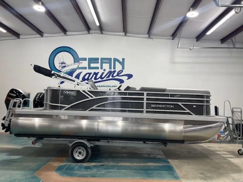 Slide: The Image of 2024 Bennington 20 SVL pontoon boat in showroom, side view. - 1