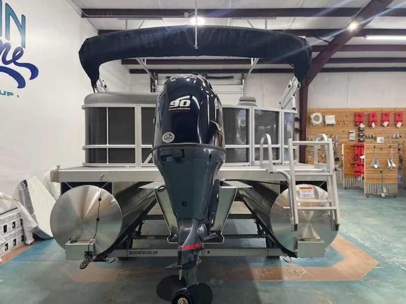 Slide: The Image of 2024 Bennington 20 SVL pontoon boat with 90 HP engine in showroom. - 11
