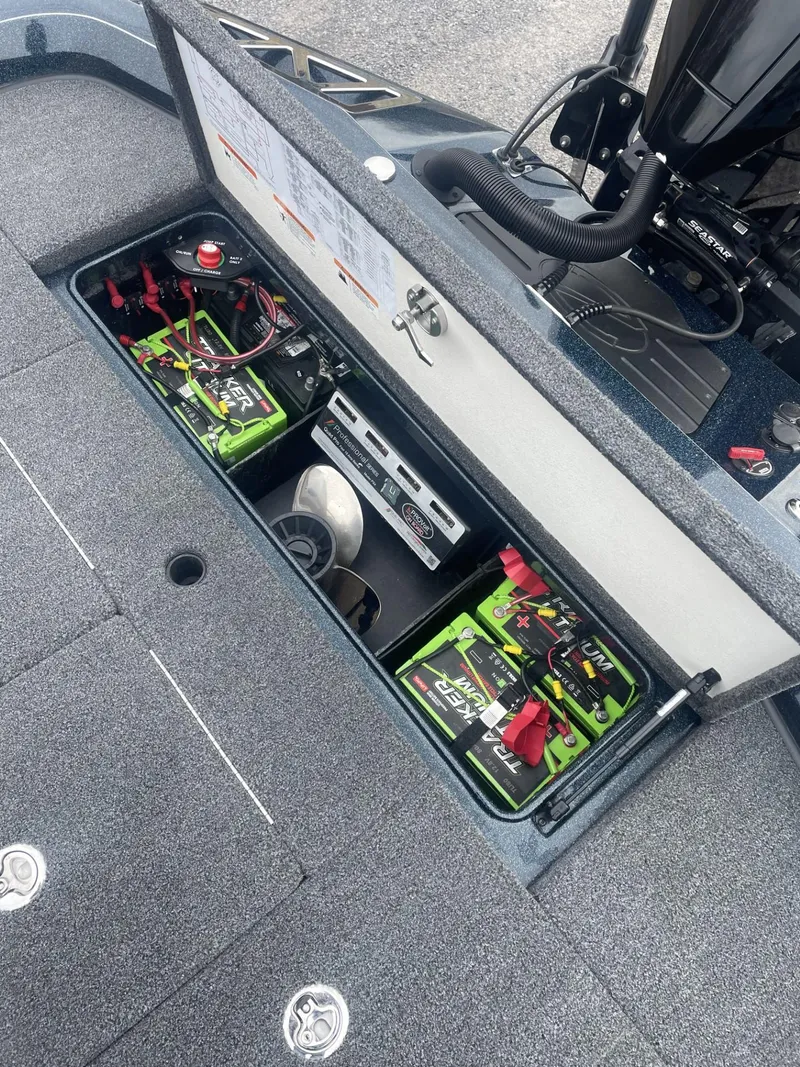 Slide: The Image of 2021 Ranger Z521L boat battery compartment with dual batteries and wiring. - 8