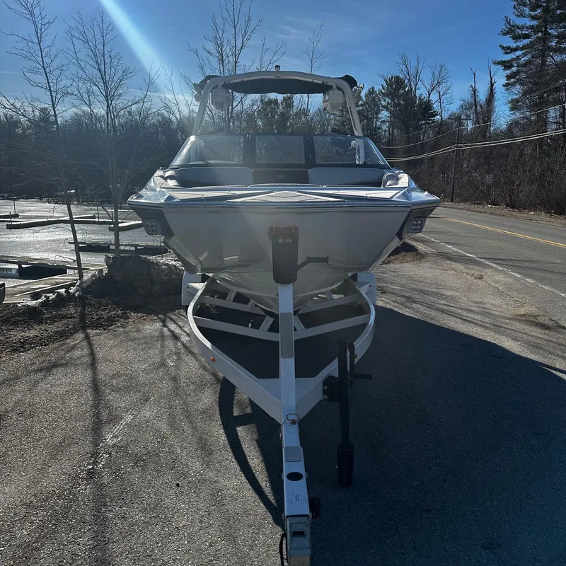 Slide: The Image of 2023 Supreme ZS232 boat on a trailer in a parking lot. - 3