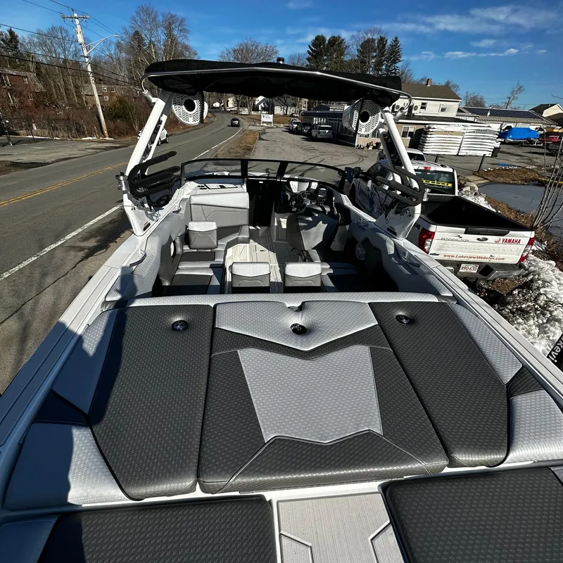 Slide: The Image of 2023 Supreme ZS232 boat interior with seating and speakers, parked on a street. - 4