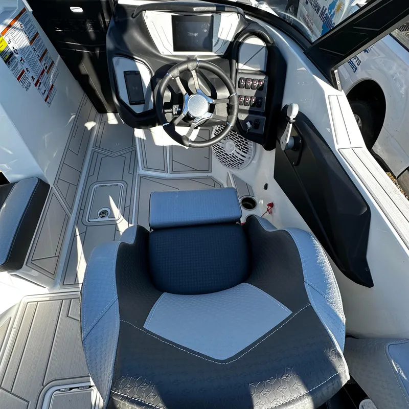 Slide: The Image of 2023 Supreme ZS232 boat cockpit with steering wheel and captain's seat. - 8