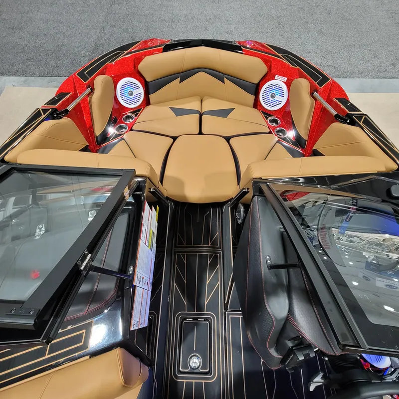 Slide: The Image of 2023 Centurion Fi21 boat interior with tan seats, red accents, and black flooring. - 10