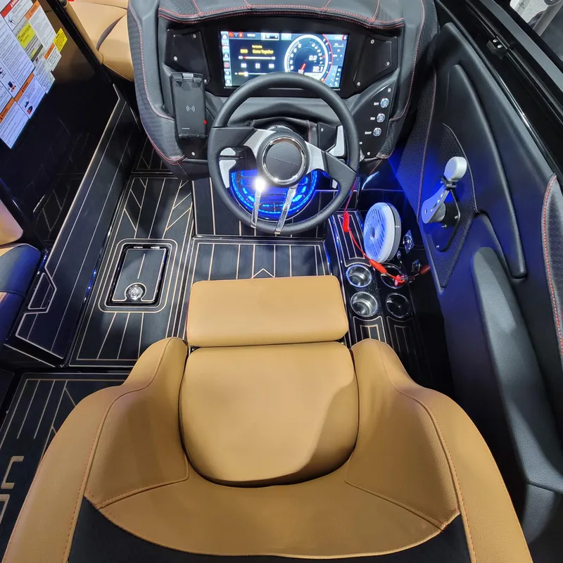 Slide: The Image of 2023 Centurion Fi21 boat cockpit with modern dashboard, steering wheel, and tan seating. - 11