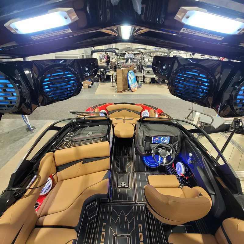 Slide: The Image of 2023 Centurion Fi21 boat interior with tan seats, advanced dashboard, and blue LED lighting. - 8