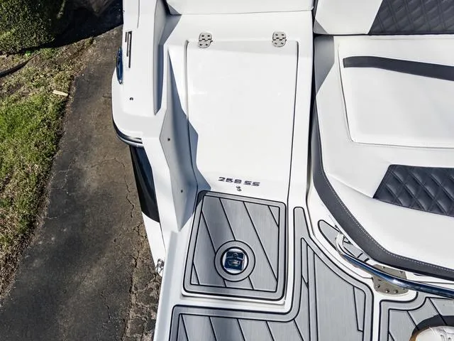 Slide: The Image of 2024 Monterey 258 SS boat deck with white and gray seating. - 12