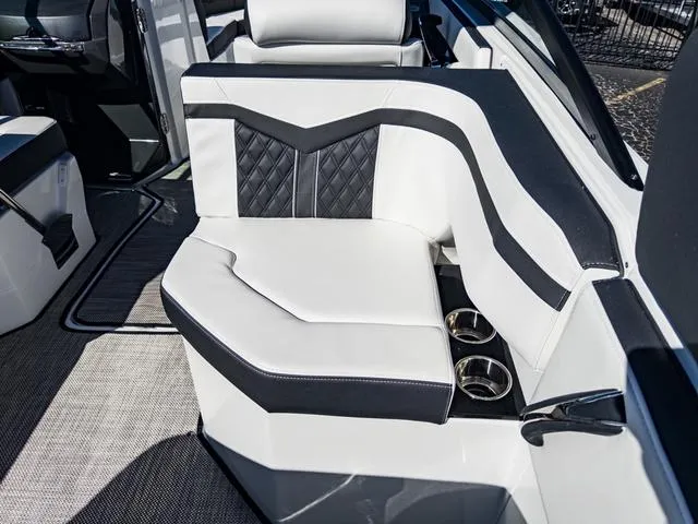 Slide: The Image of 2024 Monterey 258 SS boat interior with white and black seating and cup holders. - 18