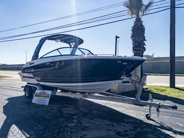 Slide: The Image of 2024 Monterey 258 SS boat on trailer, parked outdoors under clear sky. - 2
